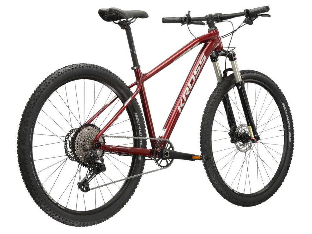 Rower górski MTB KROSS Level 6.0 M20 29 cali męski Rubinowo-srebrny rower na białym tle widoczny od tyłu po skosie góral pojazd dla sportowców do jazdy wyczynowej uniwersalny dla amatorów zwrotny łatwo wchodzi w zakręty do jazdy w mieście za miastem w lesie na górskim szlaku w błocie nie za głębokim piachu